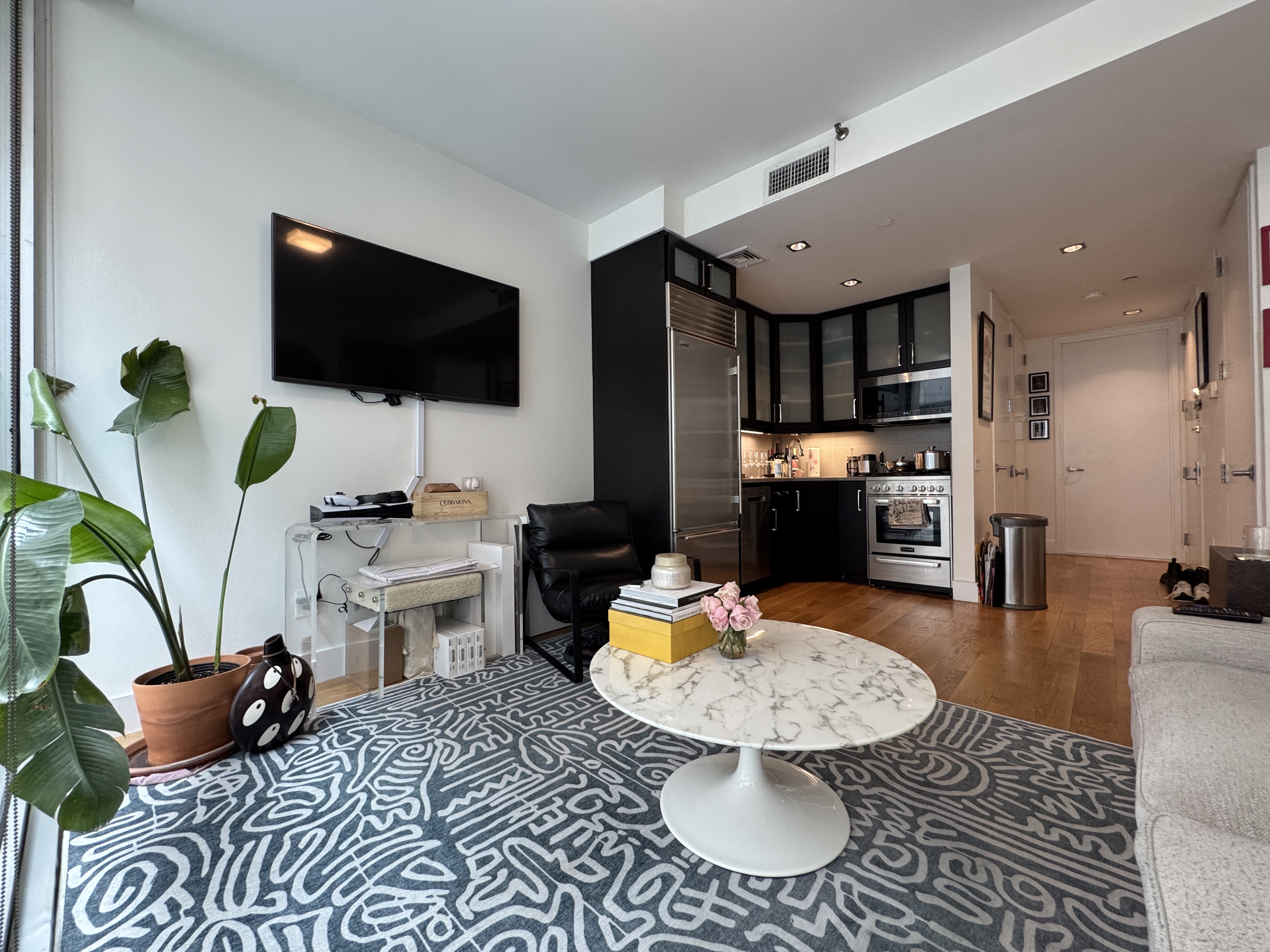 343 West 16th Street, Unit 3F Manhattan, NY 10011 - Photo 4 of 10 a living room with furniture and a flat screen tv