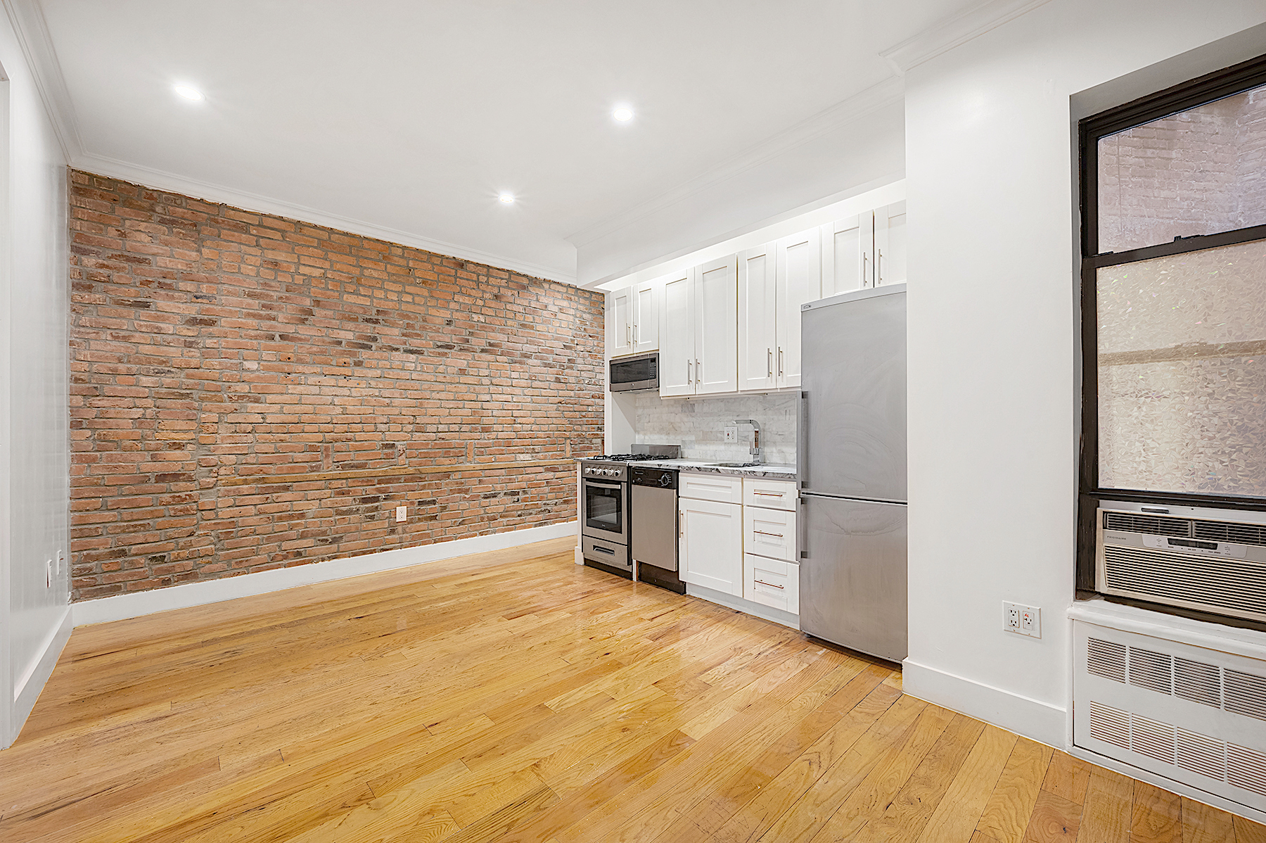 a kitchen with stainless steel appliances a refrigerator and a stove top oven