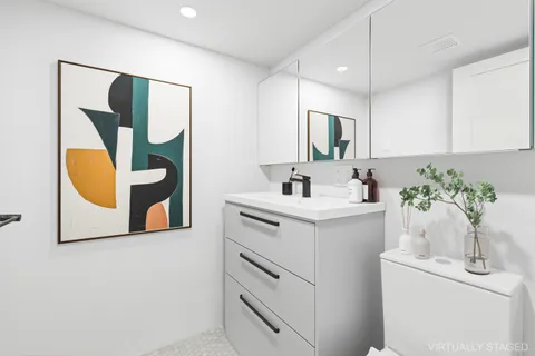 a bathroom with a sink mirror and vanity