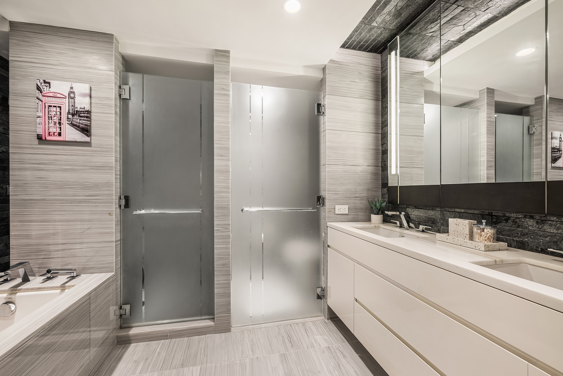 70 Charlton Street, Unit 11A Manhattan, NY 10014 - Photo 12 of 22 a bathroom with a double vanity sink and mirror