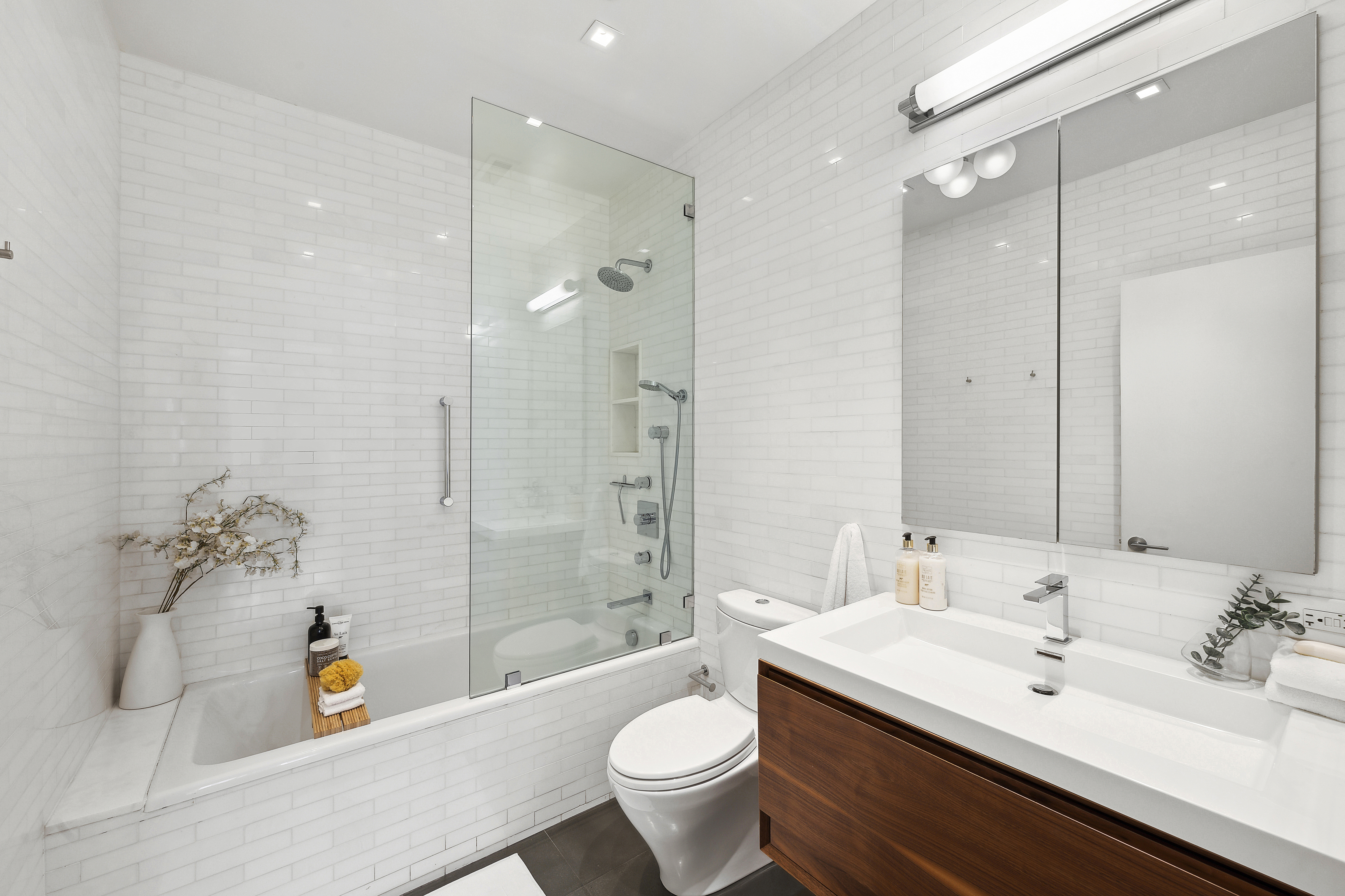 4 West 16th Street, Unit 4A Manhattan, NY 10011 - Photo 8 of 11 a bathroom with a sink a toilet a tub and shower