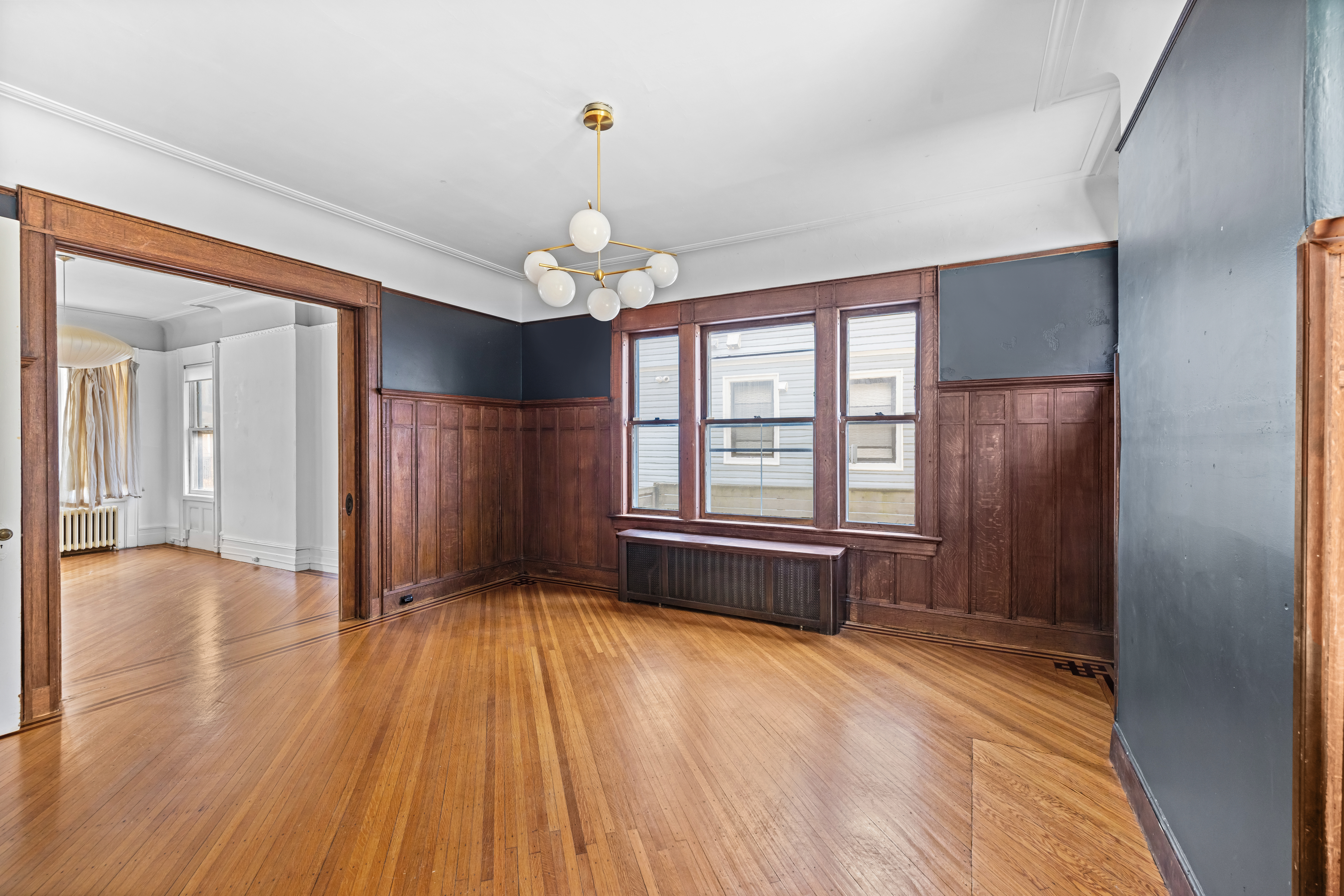 792 East 21st Street Brooklyn, NY 11210 - Photo 4 of 29 a view of livingroom with hardwood floor and window