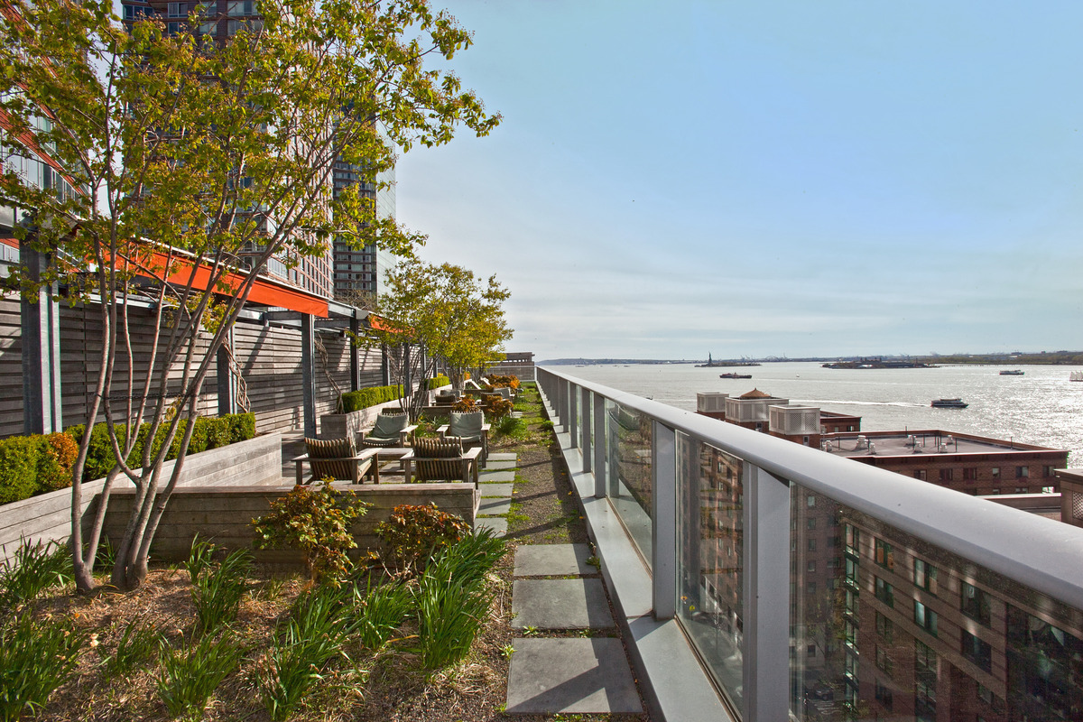 70 Little West Street, Unit 14B Manhattan, NY 10004 - Photo 15 of 17 a balcony with wooden floor and city view