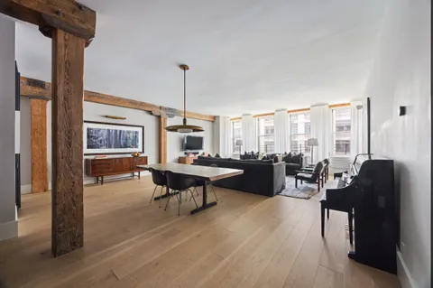 a living room with furniture a table and chairs
