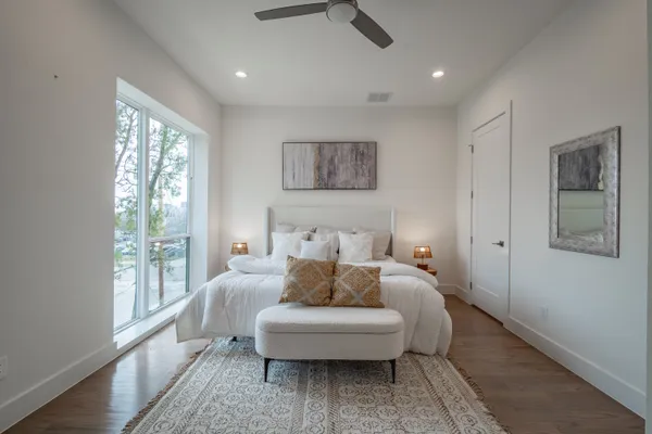 a bedroom with a bed and wooden floor