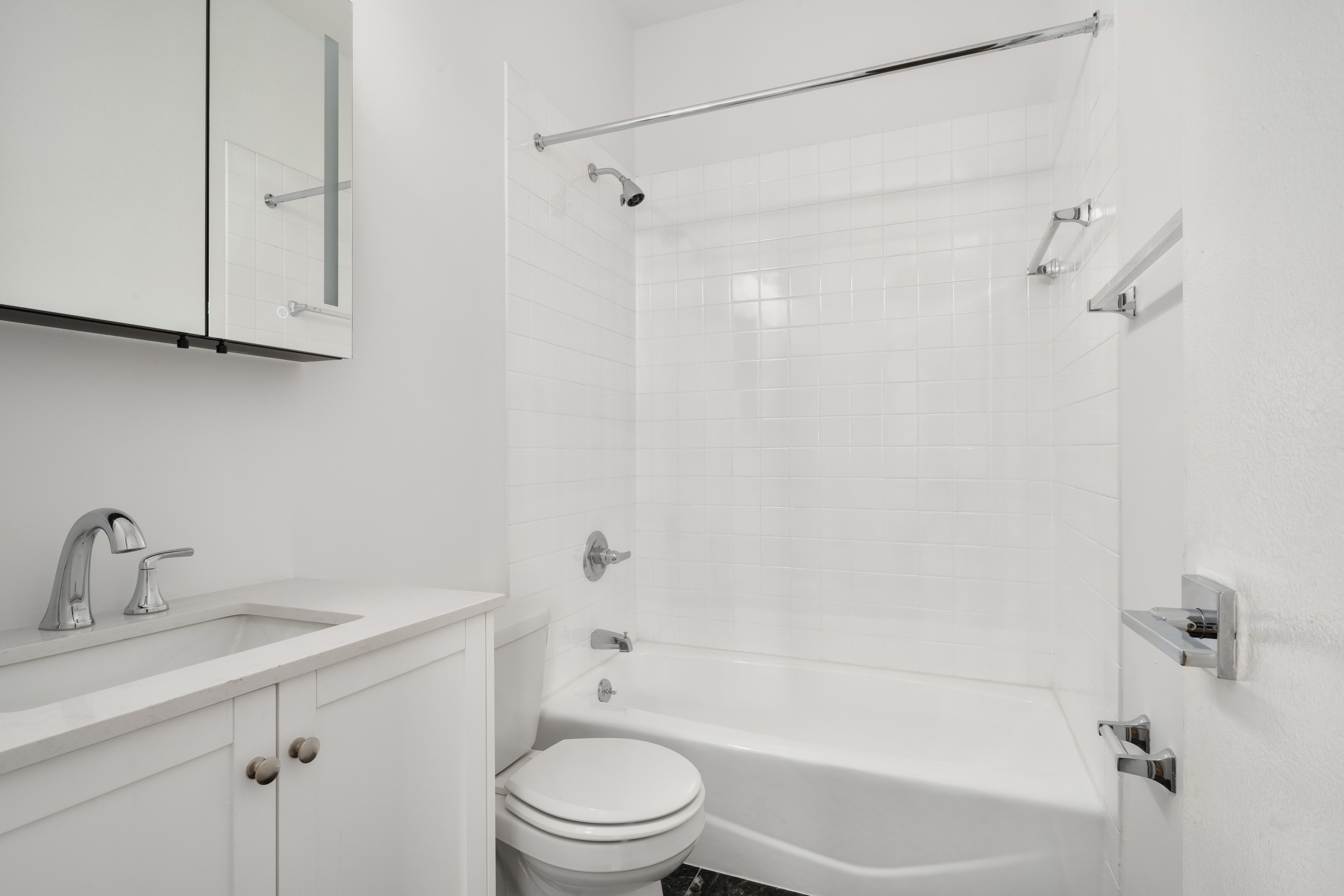 130 West 80th Street, Unit 2R Manhattan, NY 10024 - Photo 6 of 8 a bathroom with a bathtub shower sink vanity and toilet