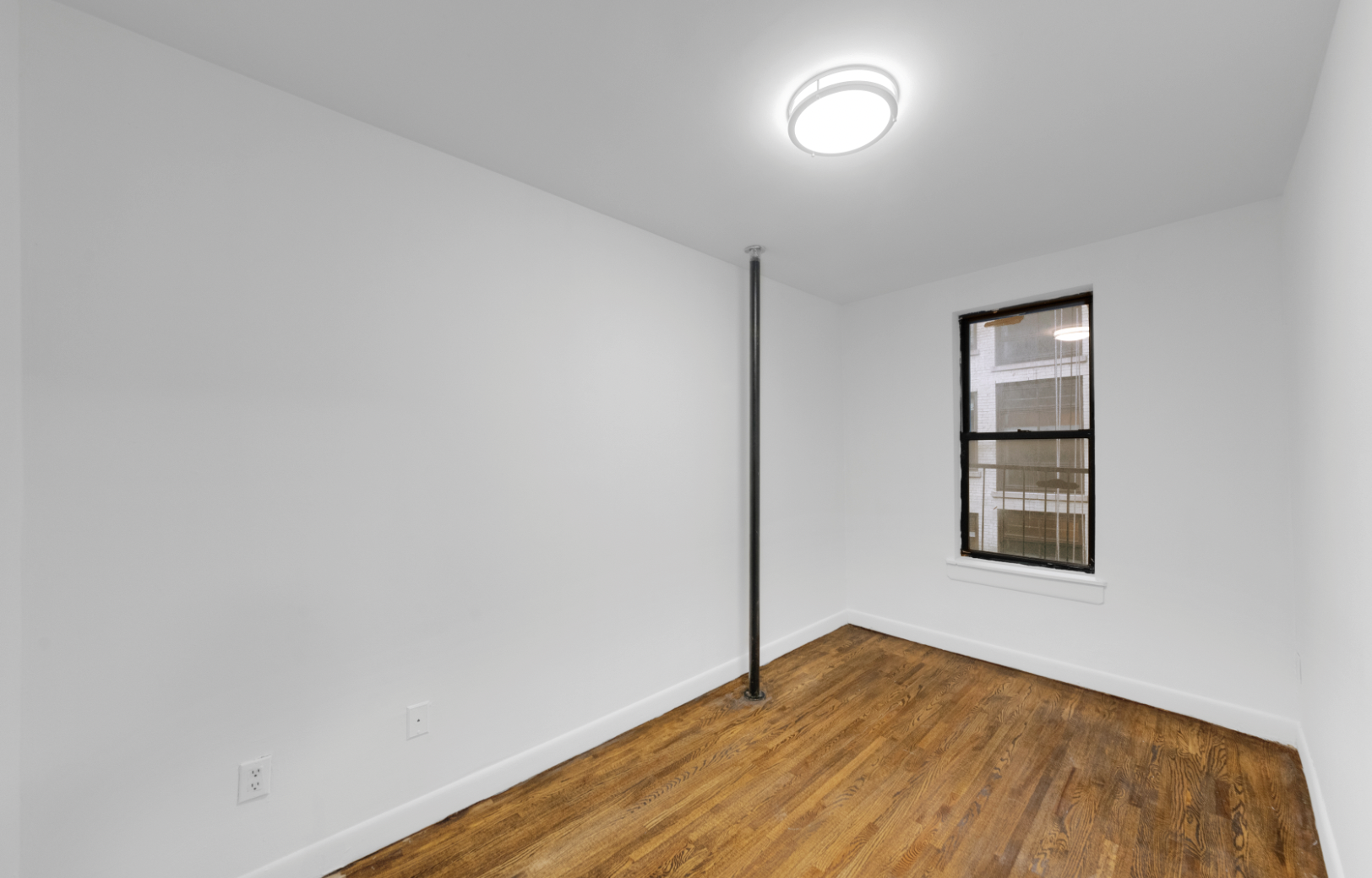 24 East 97th Street, Unit 21 Manhattan, NY 10128 - Photo 3 of 5 an empty room with a window