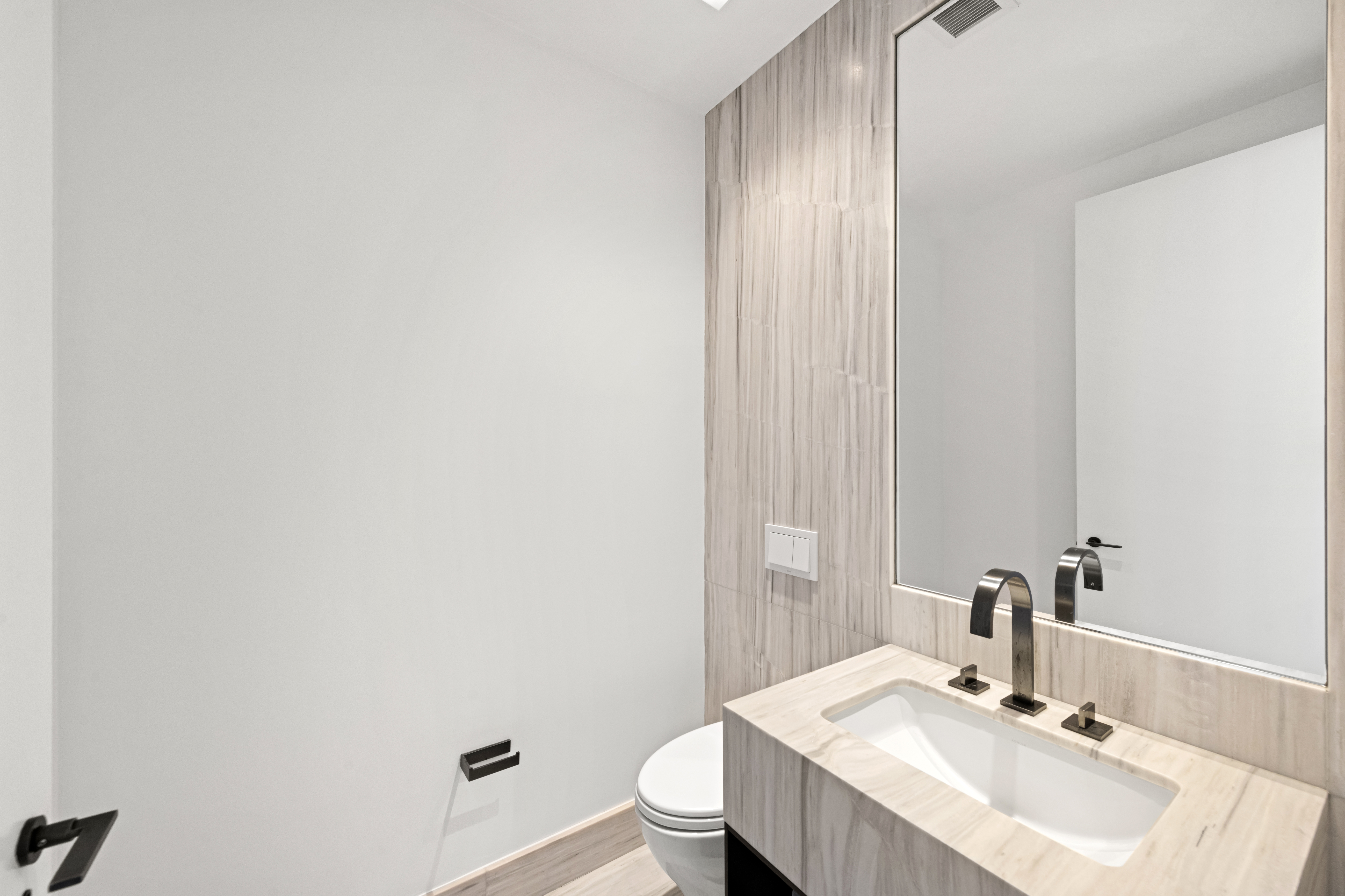 111 Murray Street, Unit 51EAST Manhattan, NY 10007 - Photo 22 of 42 a bathroom with a sink a toilet and mirror