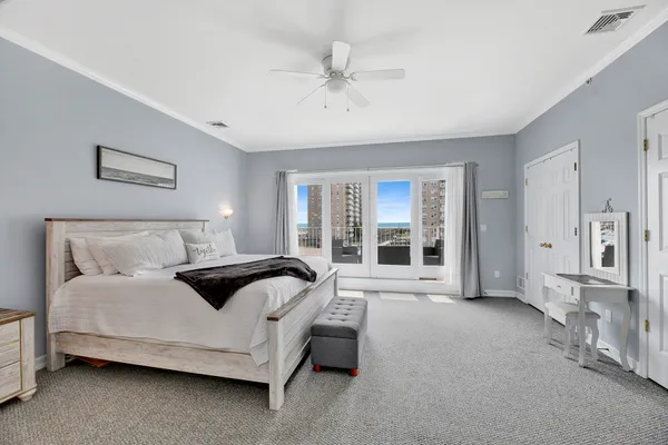 a spacious bedroom with a bed and glass door