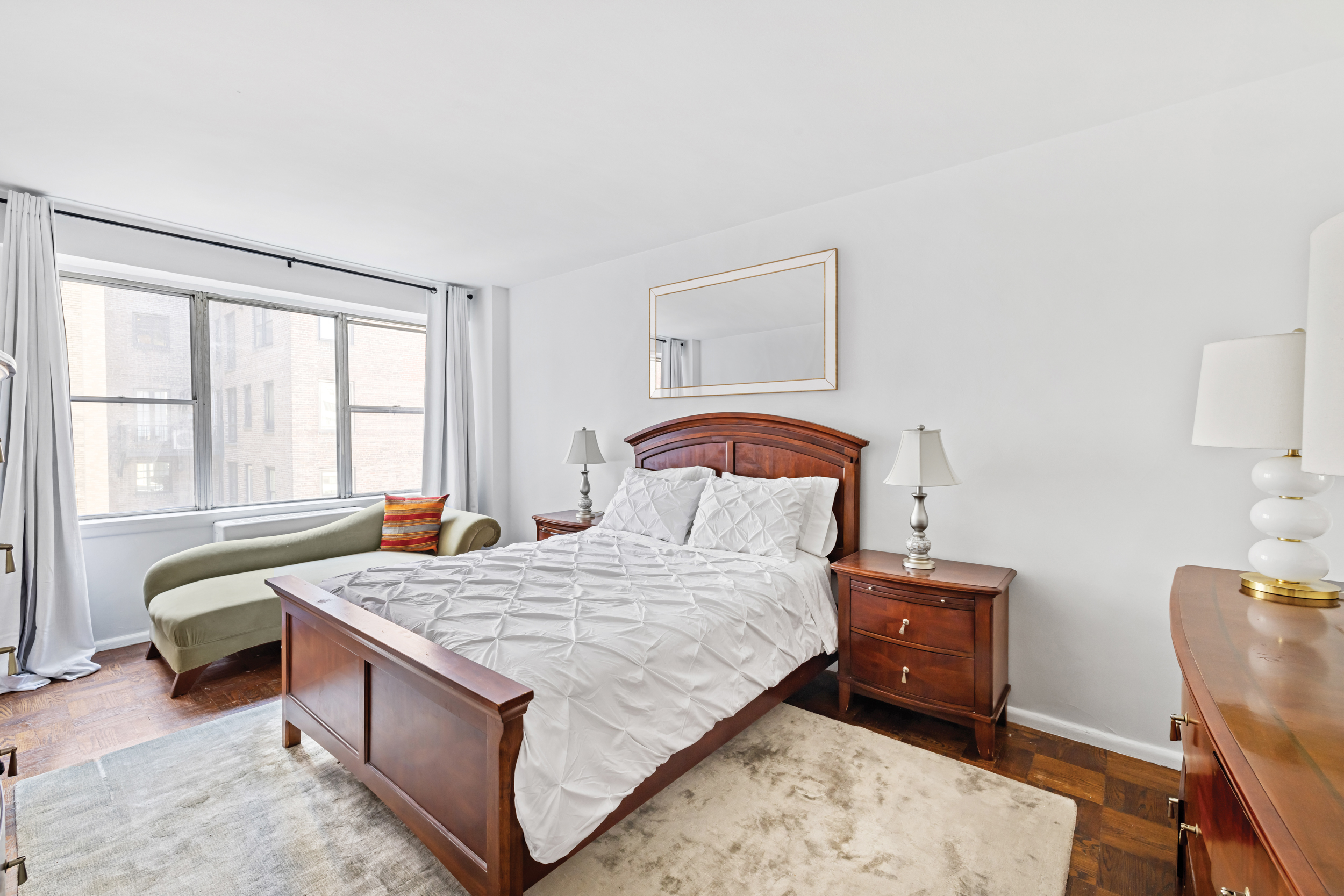 12 Beekman Place, Unit 9D Manhattan, NY 10022 - Photo 6 of 8 a bedroom with a bed and a window