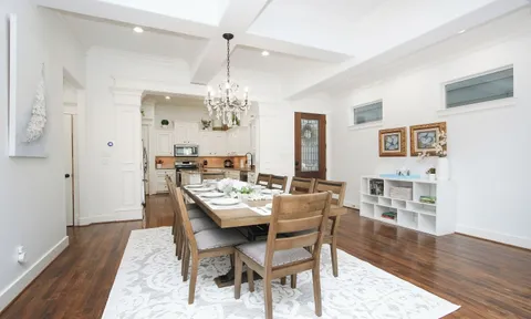 a kitchen with stainless steel appliances granite countertop a stove top oven a refrigerator a sink and dishwasher with white cabinets