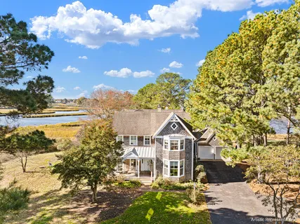 a view of a lake with lawn chairs