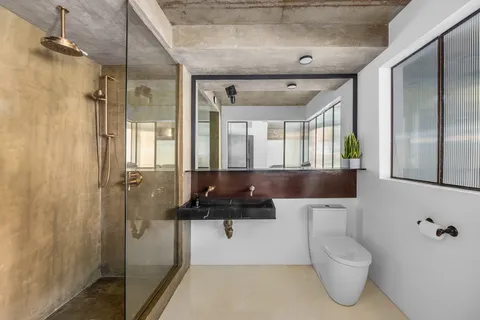 a bathroom with a toilet a sink and mirror