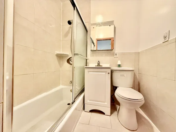 a bathroom with a toilet sink and shower