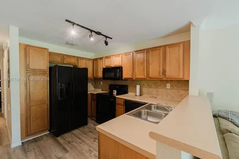 a kitchen with a refrigerator and a sink