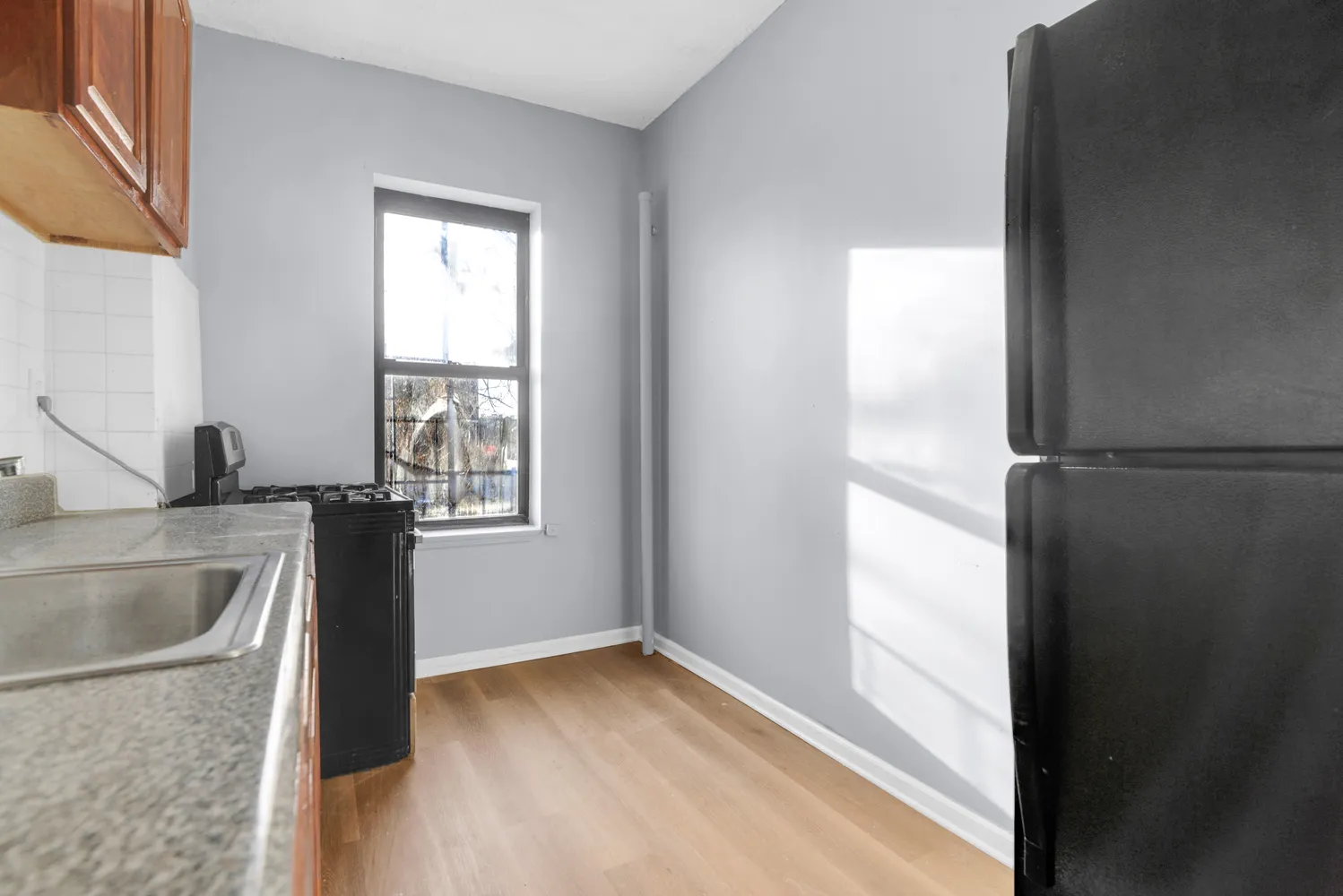 a kitchen with stainless steel appliances granite countertop a sink stove and refrigerator