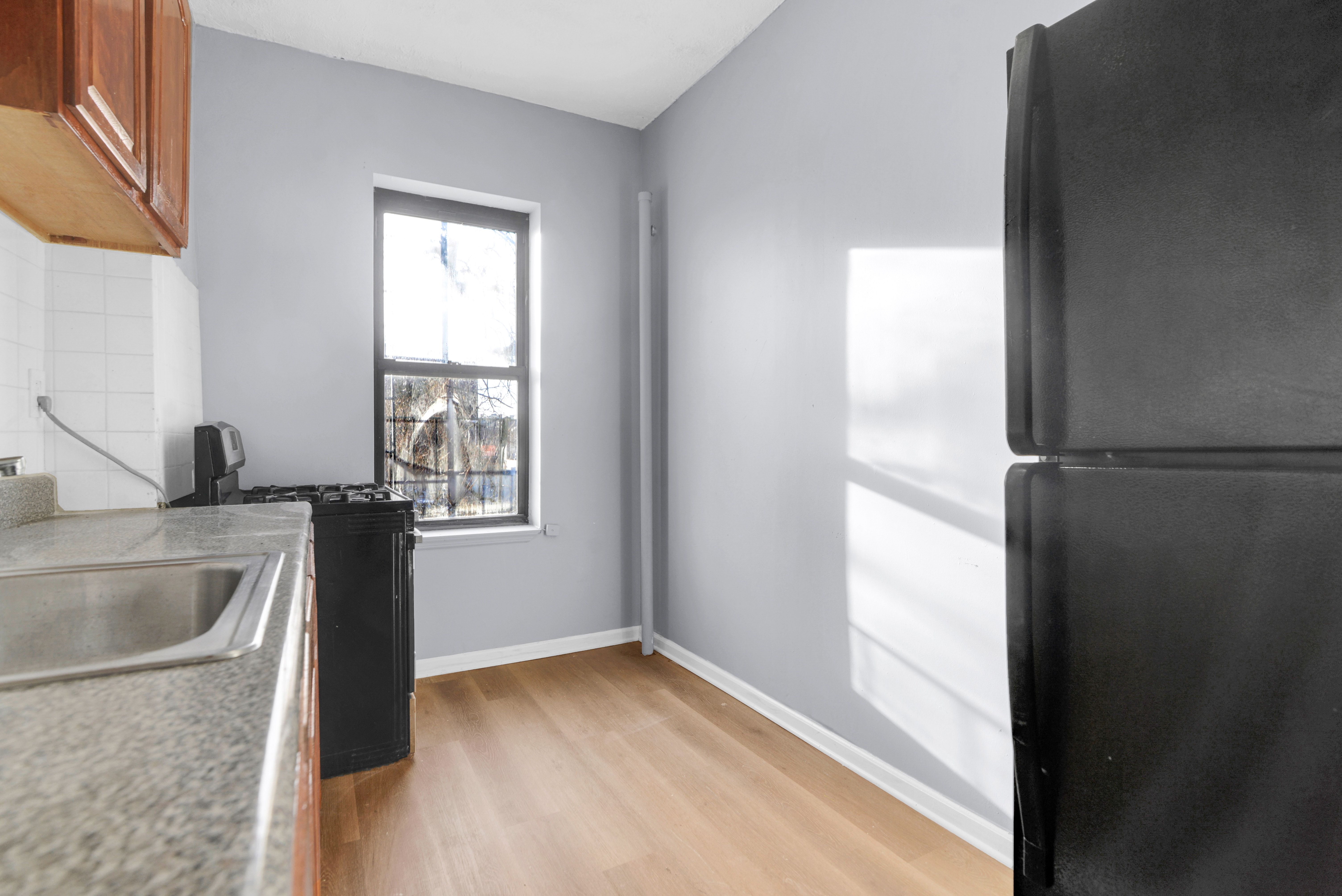 2302 Bedford Avenue, Unit 3 Brooklyn, NY 11226 - Photo 17 of 25 a view of a kitchen from a sink and a window