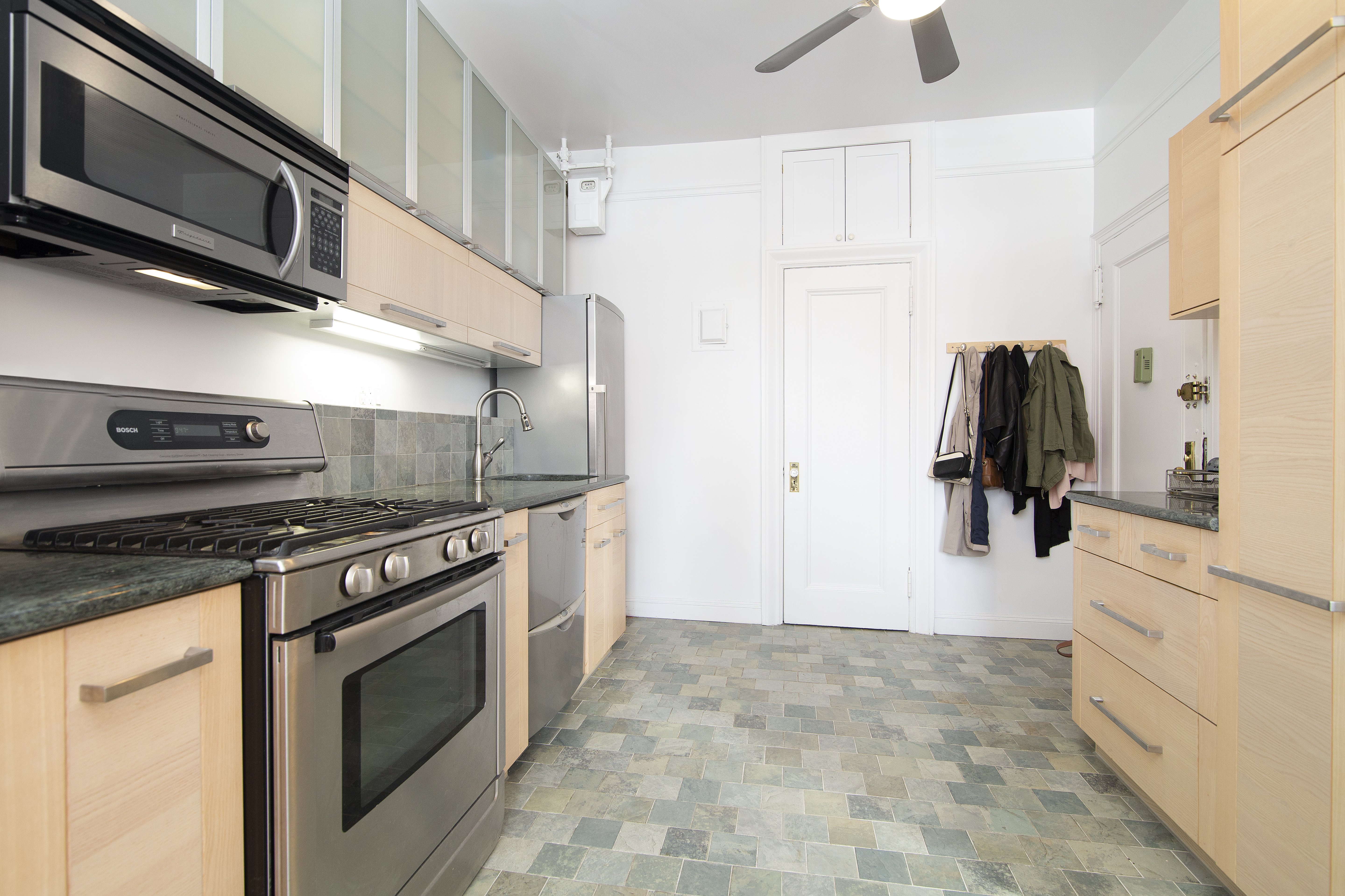 504 West 110th Street, Unit 8F Manhattan, NY 10025 - Photo 2 of 7 a kitchen with stainless steel appliances granite countertop a stove and a refrigerator