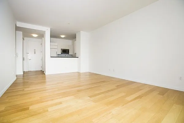 46-30 Center Boulevard, Unit 1209 Queens, NY 11109 - Photo 8 of 26 a view of empty room with wooden floor