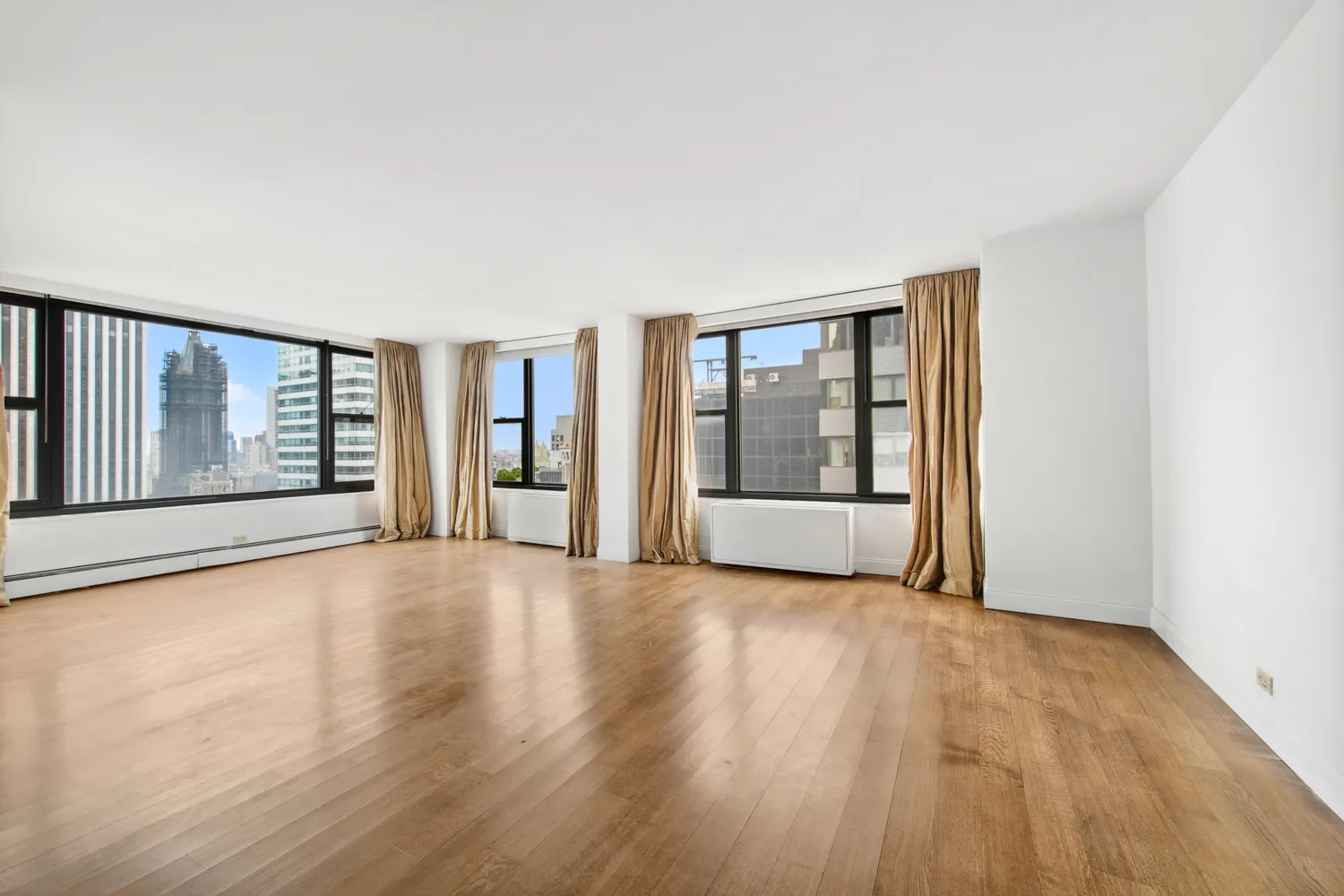 a view of an empty room with glass door and a window