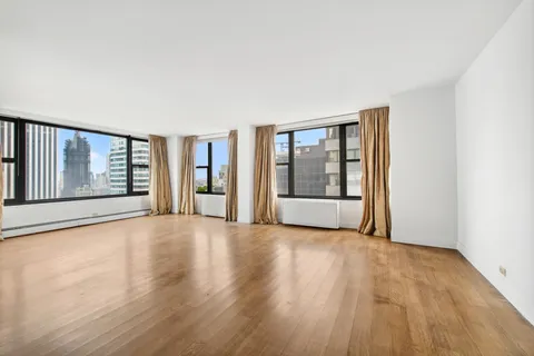 a view of an empty room with glass door and a window
