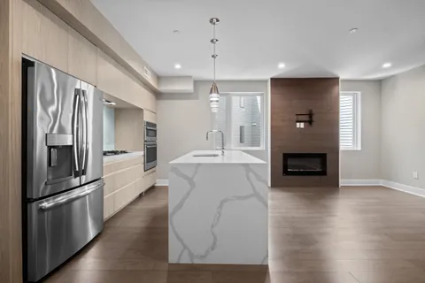a kitchen with stainless steel appliances granite countertop a refrigerator and a sink