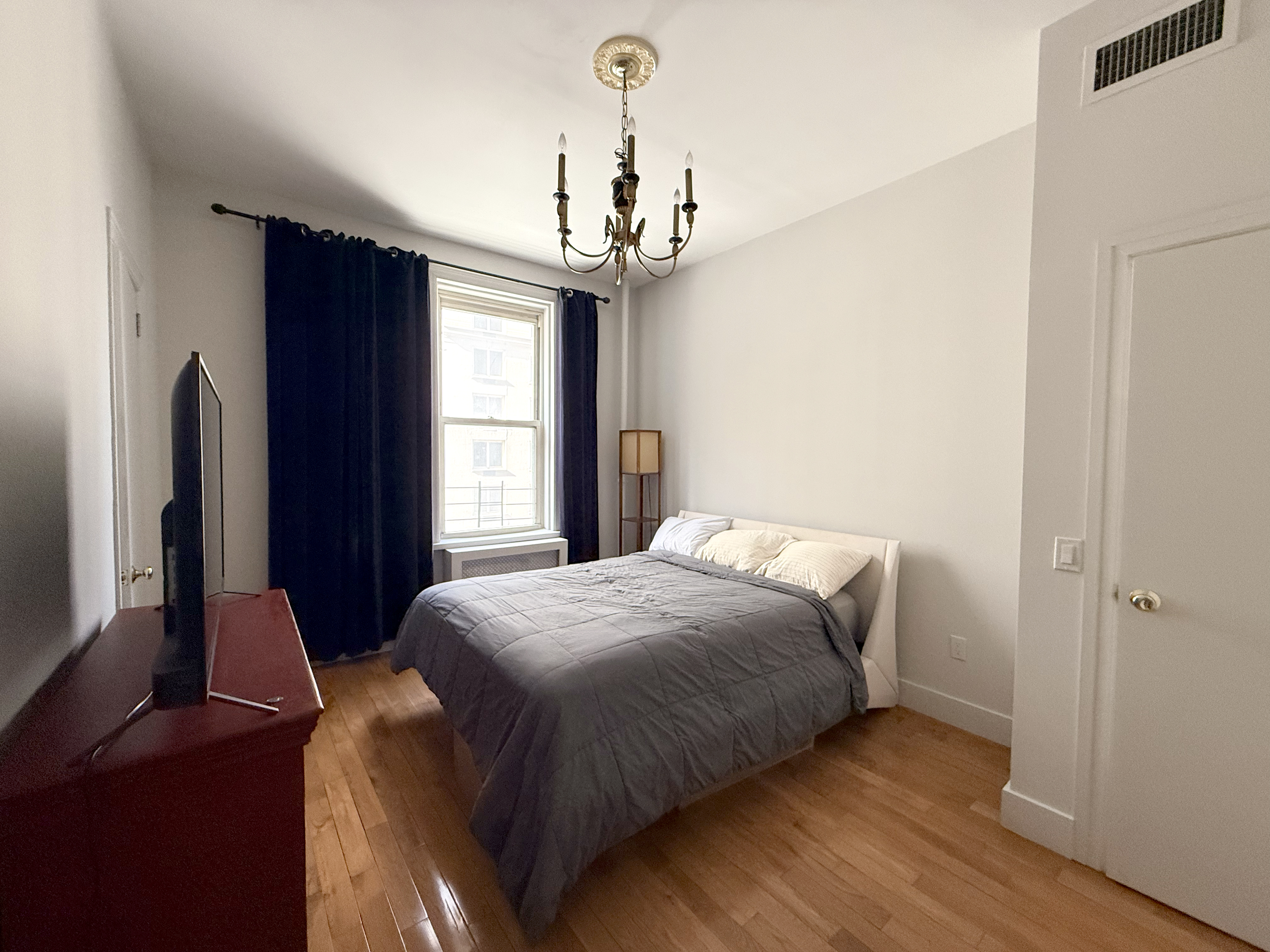 57 West 58th Street, Unit 8A Manhattan, NY 10019 - Photo 5 of 8 a bedroom with bed and window