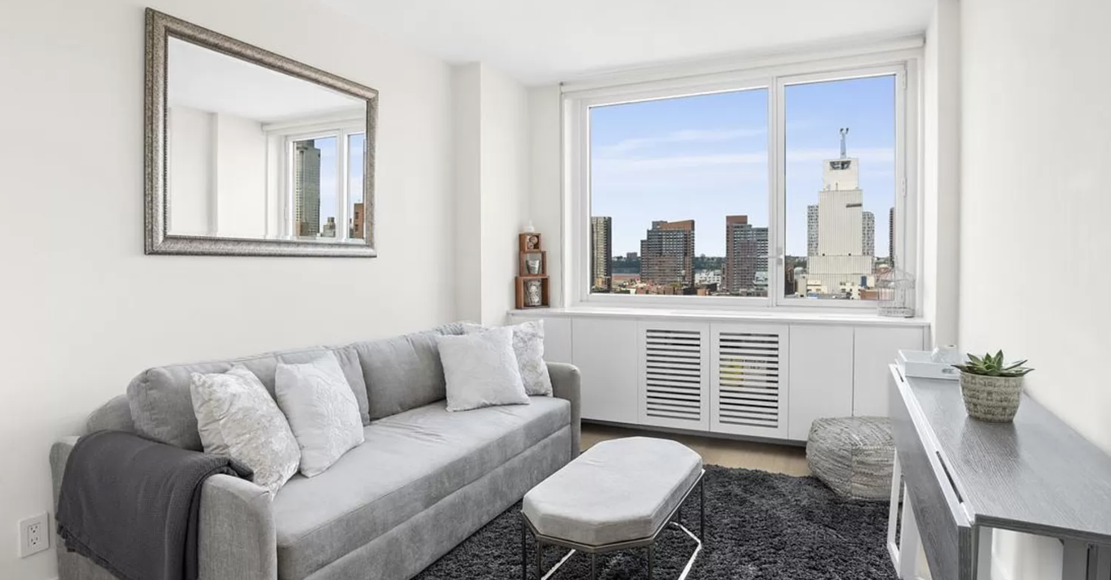 301 West 53rd Street, Unit 14C Manhattan, NY 10019 - Photo 3 of 12 a living room with furniture and a window