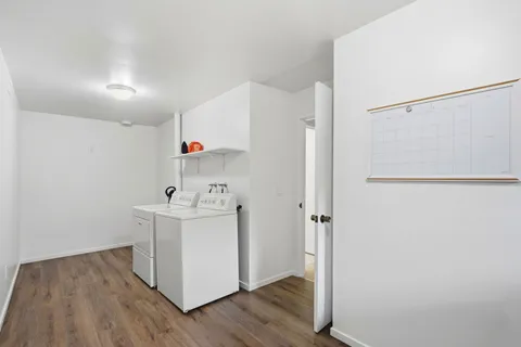 a view of utility room with wooden floor