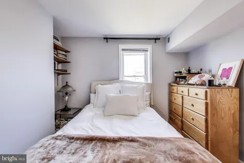 a bedroom with a bed and a cabinets