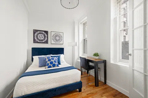 a bedroom with a bed and a window