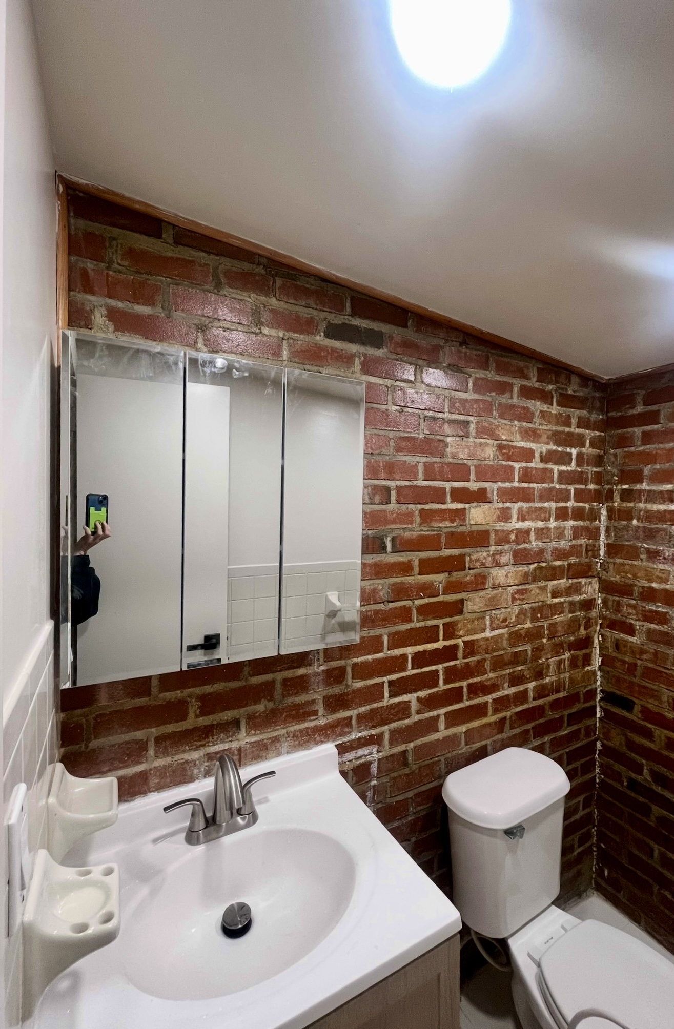 226 10th Street, Unit 3 Brooklyn, NY 11215 - Photo 10 of 10 a bathroom with a toilet a sink and mirror