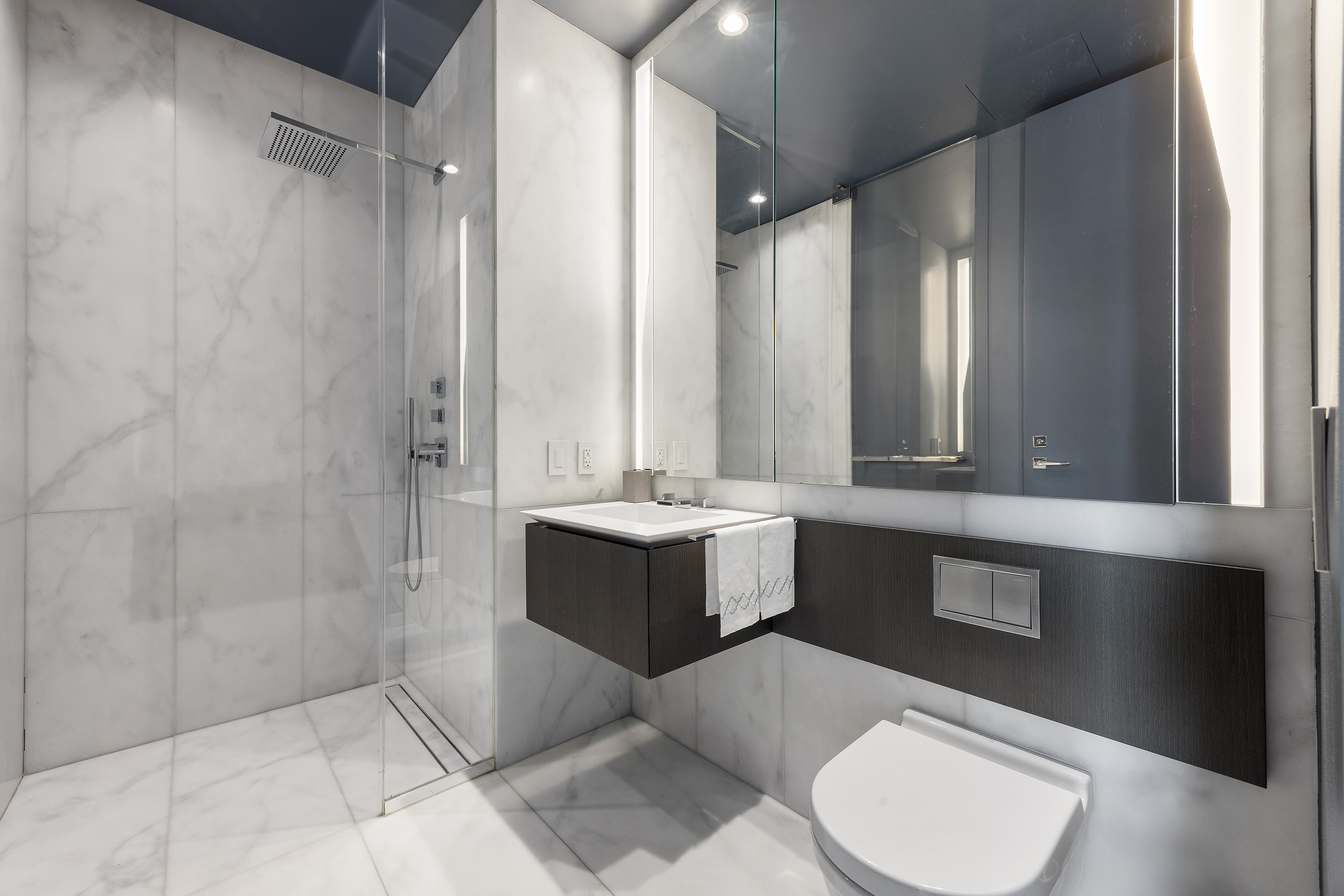 520 West 28th Street, Unit PH37 Manhattan, NY 10001 - Photo 37 of 45 a bathroom with a double vanity sink toilet mirror and bathtub