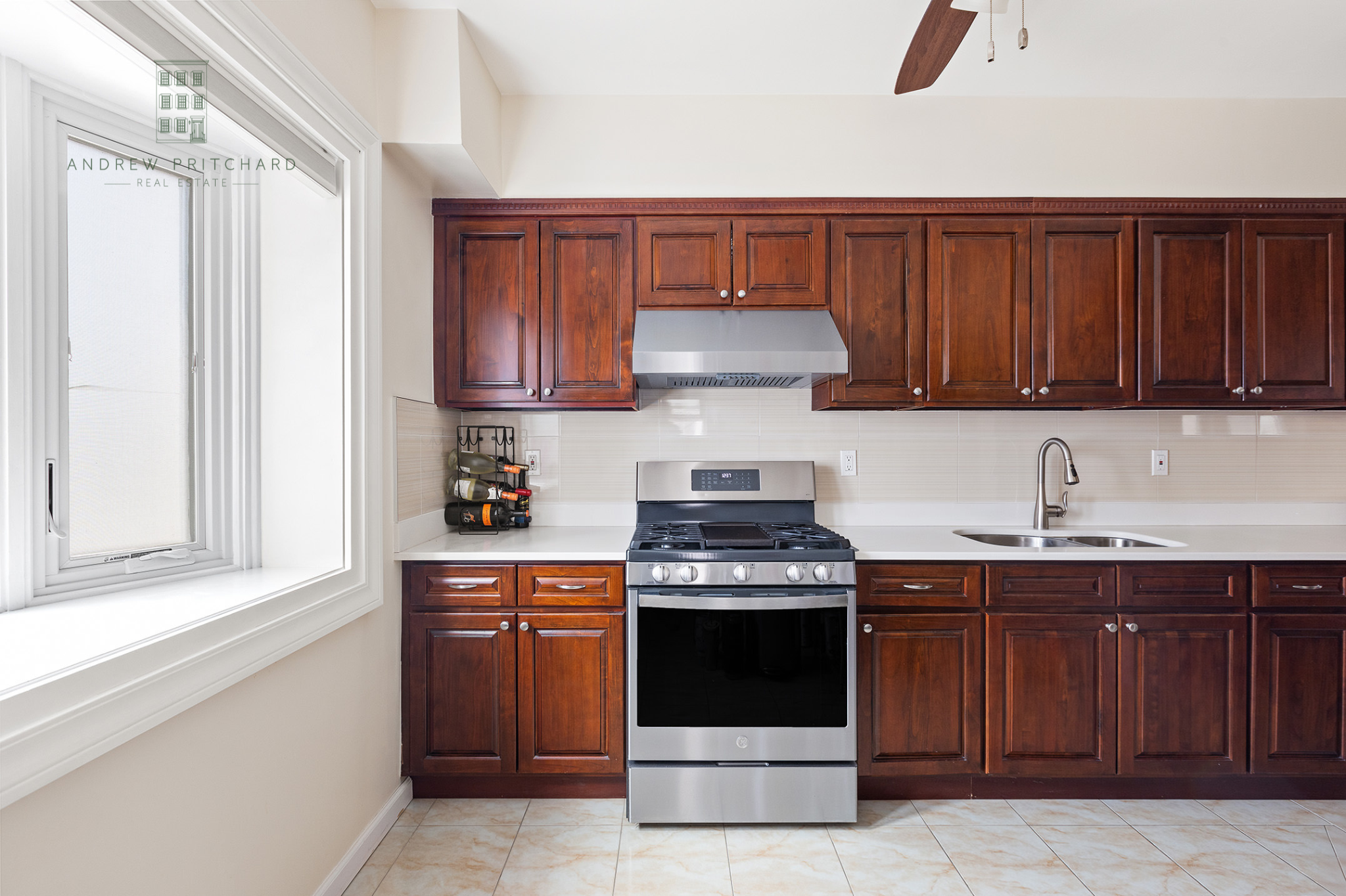1140 78th Street Brooklyn, NY 11228 - Photo 4 of 12 a kitchen with a stove and a sink