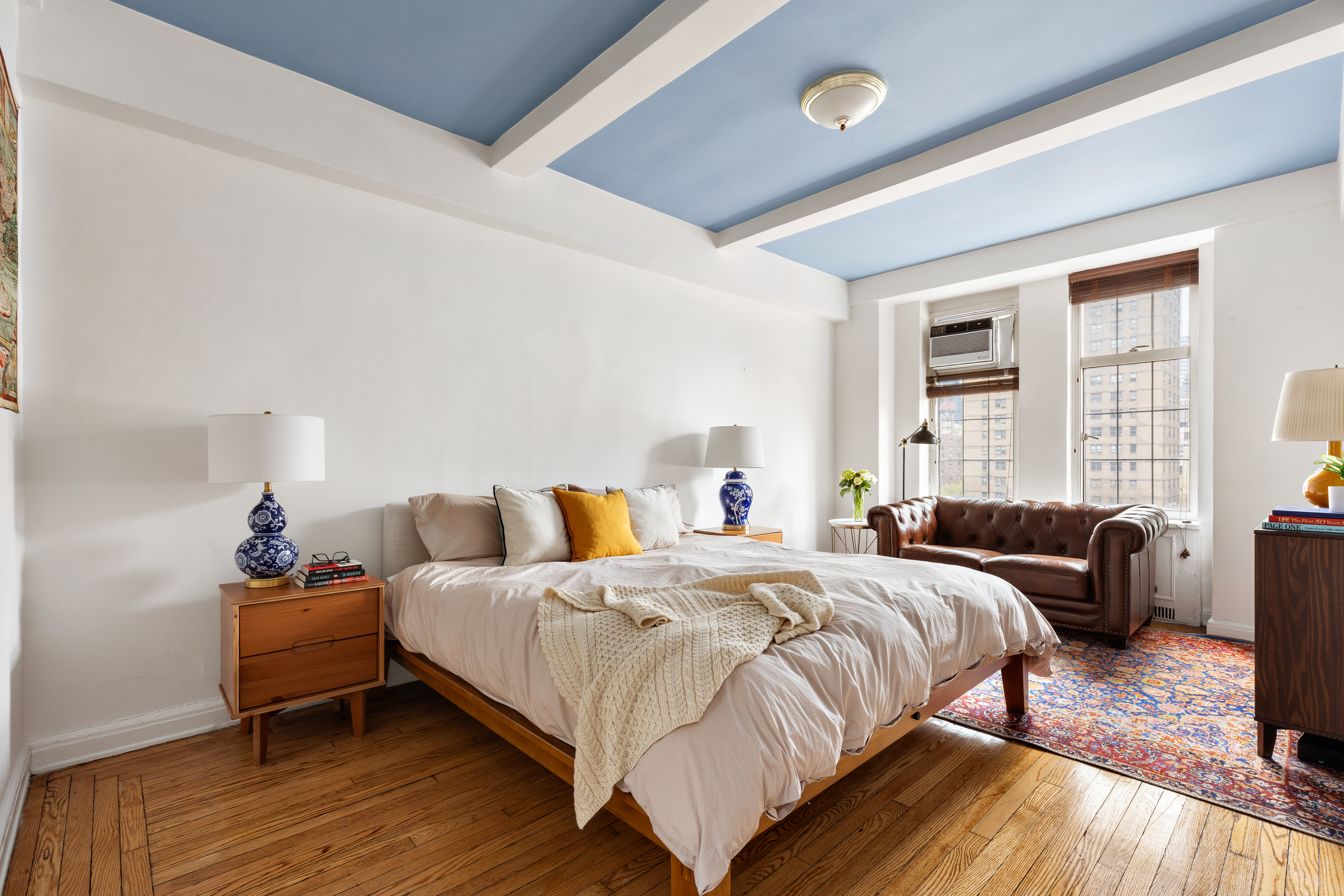 410 West 24th Street, Unit 9K Manhattan, NY 10011 - Photo 5 of 10 a bedroom with a bed and wooden floor