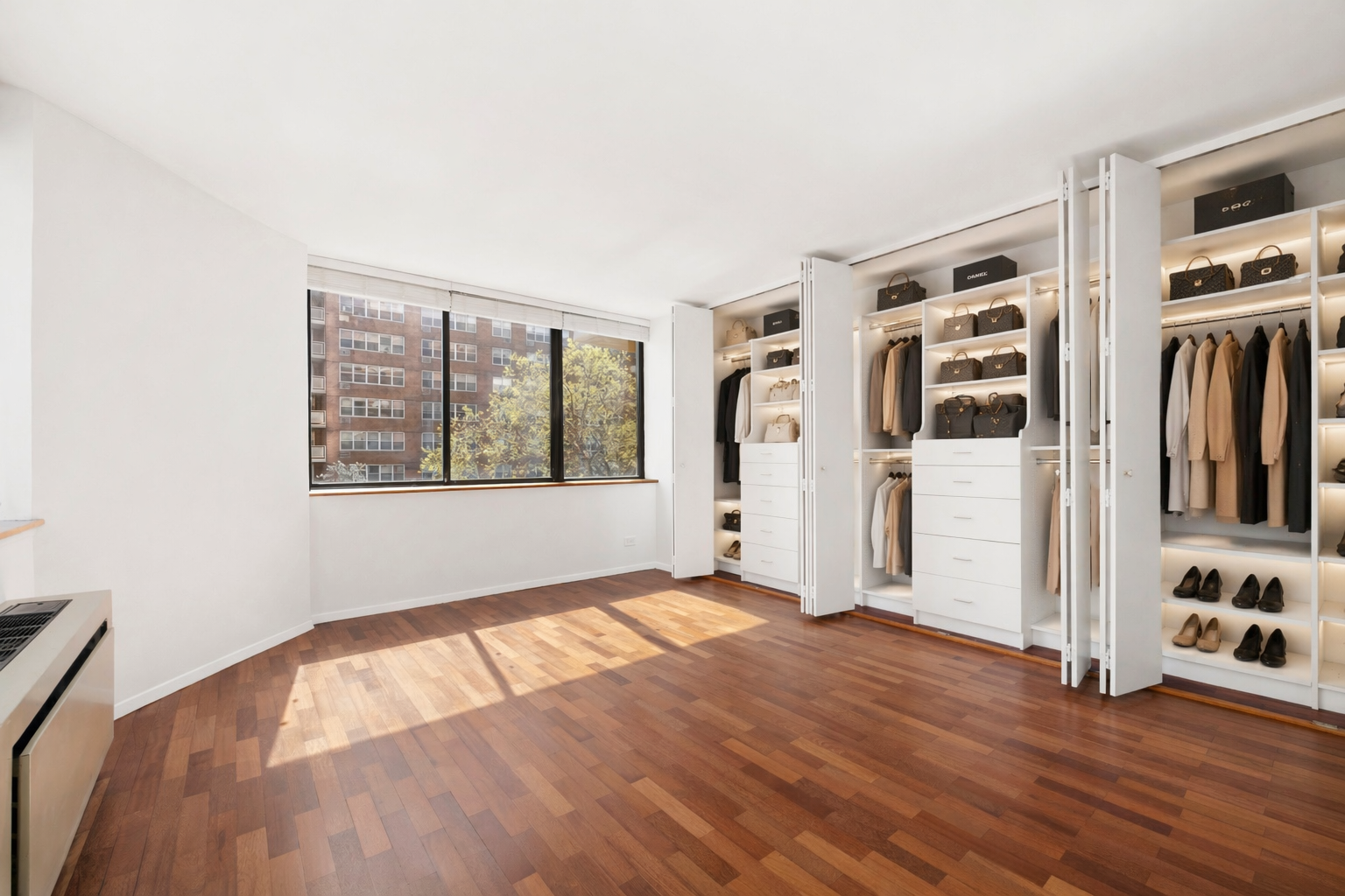 330 East 75th Street, Unit 3B Manhattan, NY 10021 - Photo 6 of 10 a view of an empty room with window and wooden floor