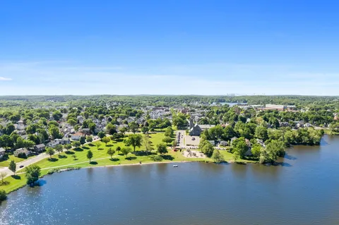 an aerial view of a houses with a lake view