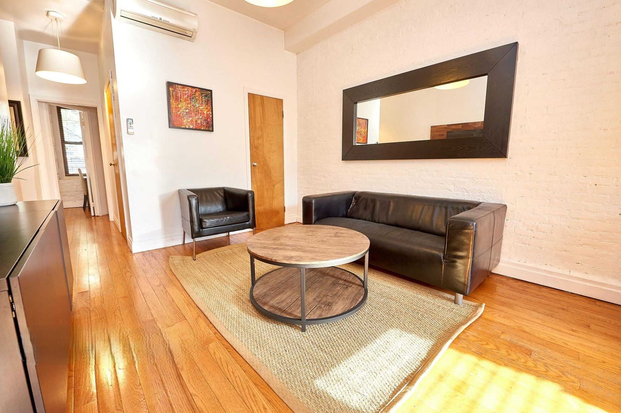 170 Elizabeth Street, Unit 1 Manhattan, NY 10012 - Photo 3 of 16 a living room with furniture and a wooden floor