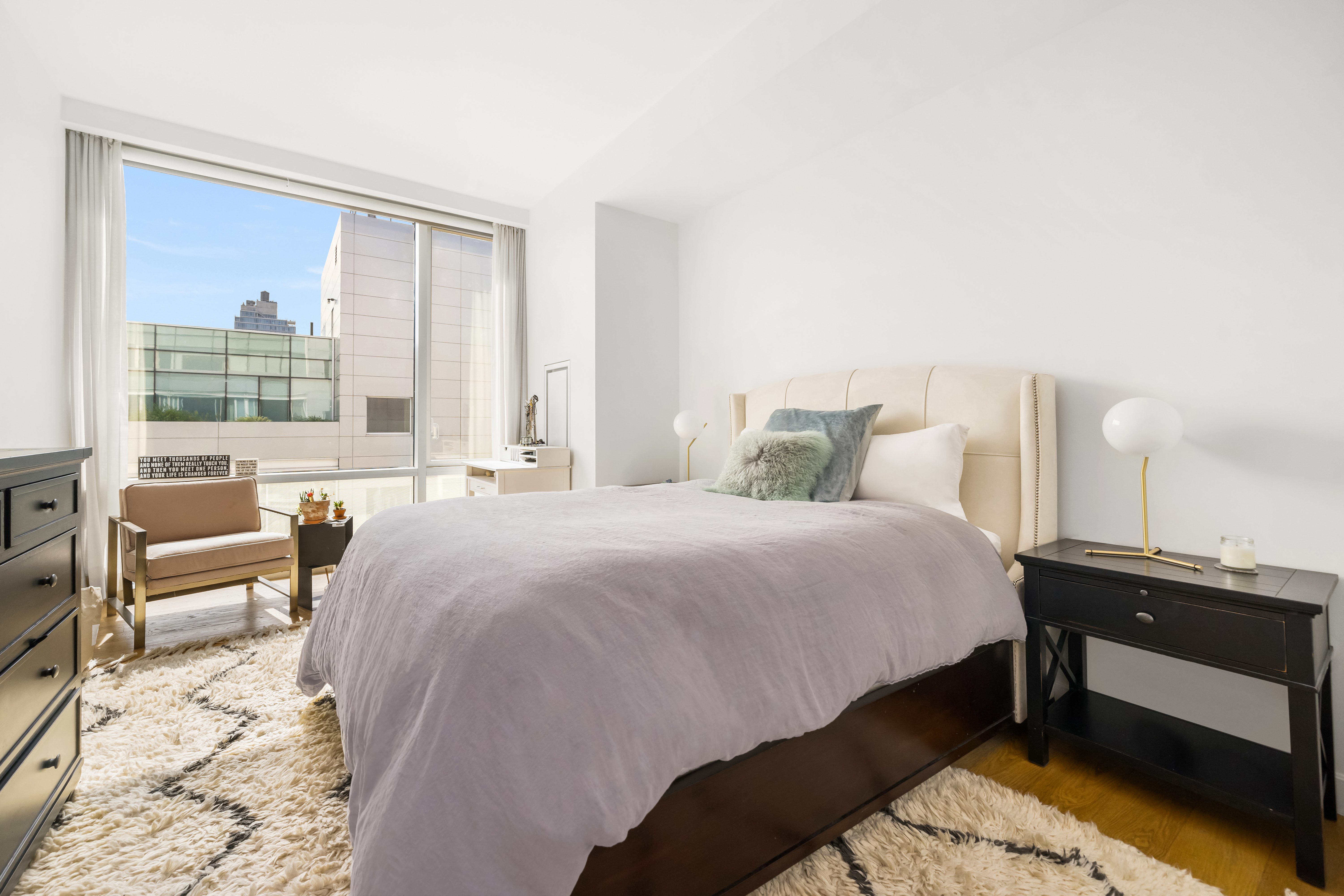 311 West Broadway, Unit 8A Manhattan, NY 10013 - Photo 8 of 10 a bedroom with a bed and a large window