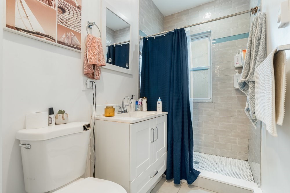 24 Buttonwood Street Boston, MA 02125 - Photo 30 of 43 a bathroom with a sink toilet and shower