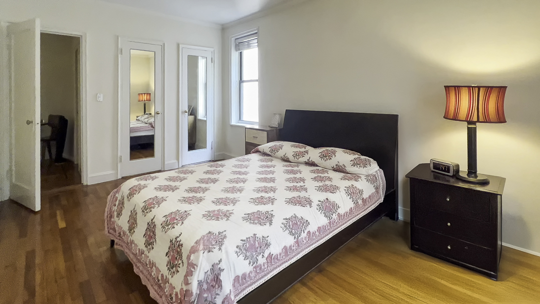 208 East 28th Street, Unit 4A Manhattan, NY 10016 - Photo 5 of 12 a bedroom with a bed and a lamp
