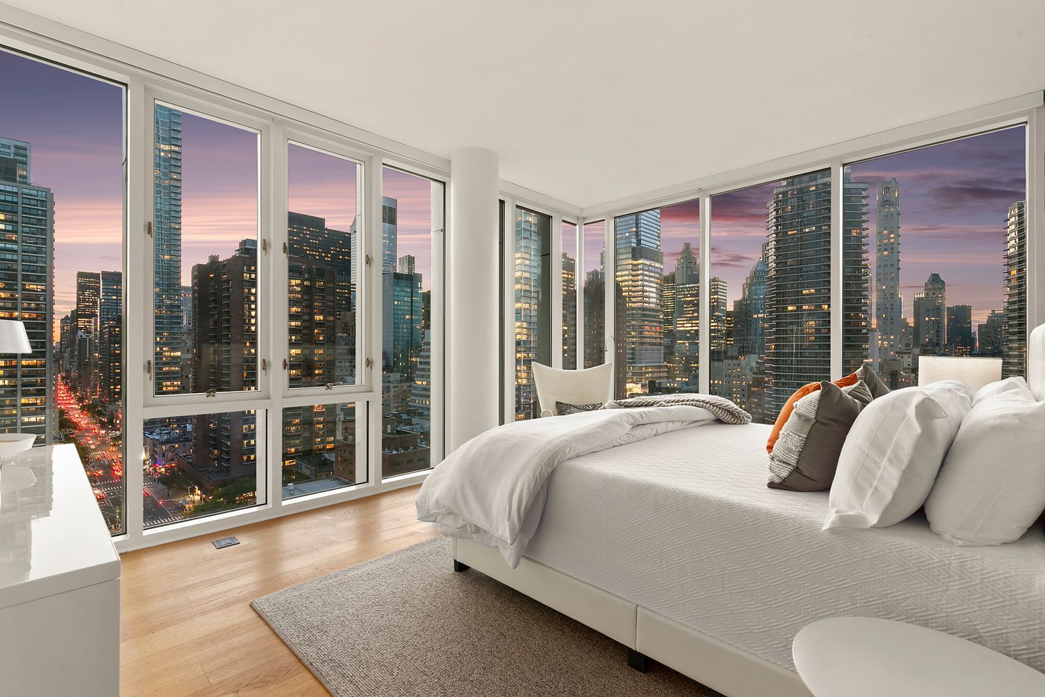 301 East 61st Street, Unit 16A Manhattan, NY 10065 - Photo 8 of 17 a bedroom with a bed and glass window