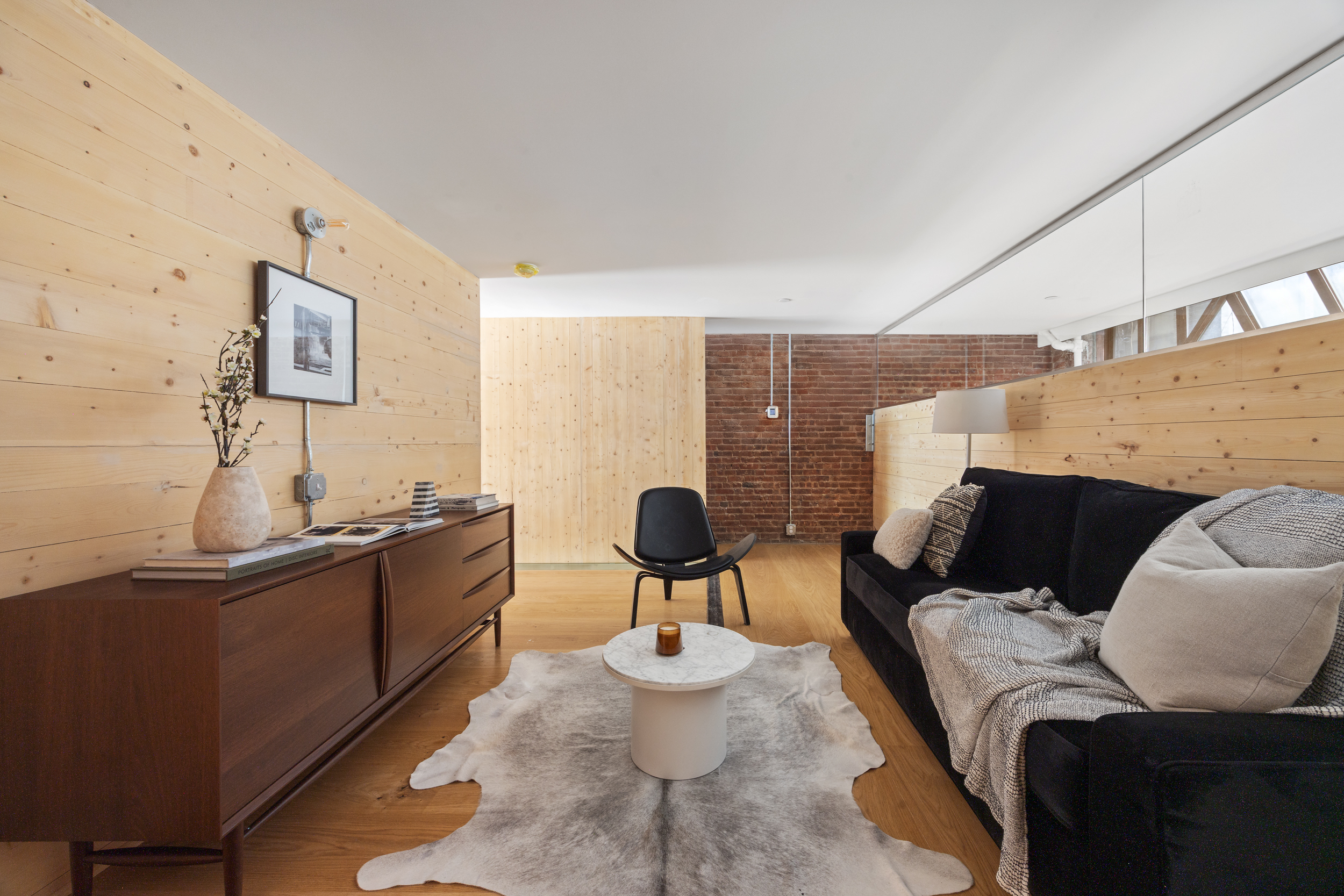 74 Reade Street, Unit 1E Manhattan, NY 10007 - Photo 12 of 22 a living room with furniture and a large mirror