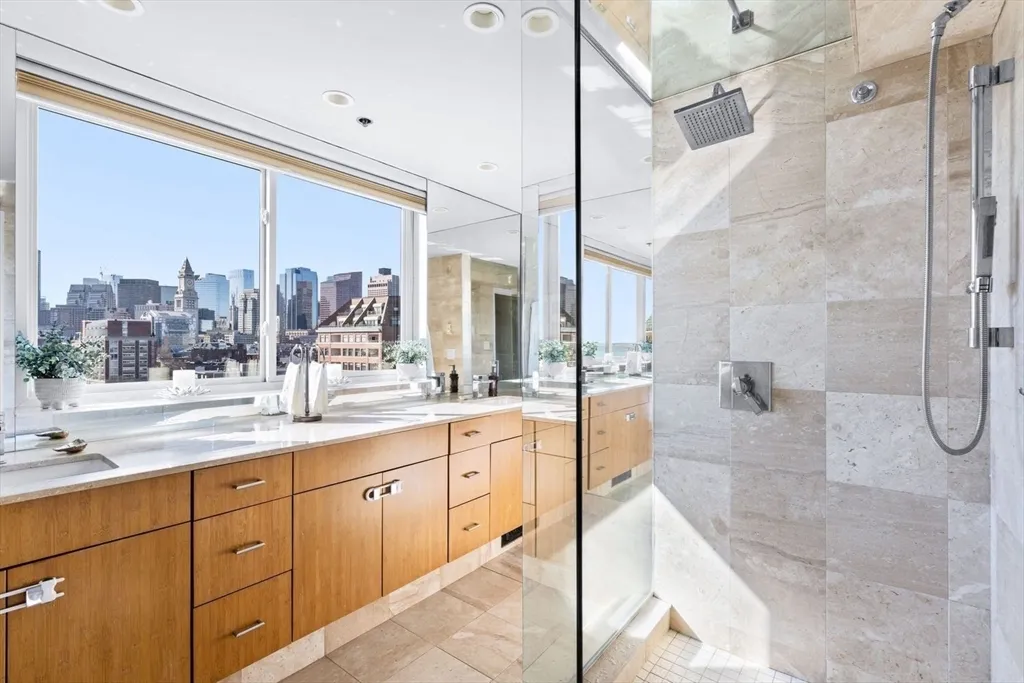 a large bathroom with a double vanity sink mirror and shower