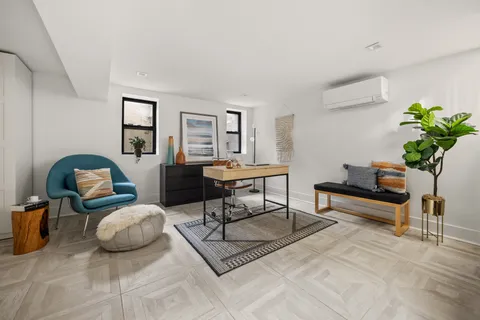 a living room with furniture and a potted plant