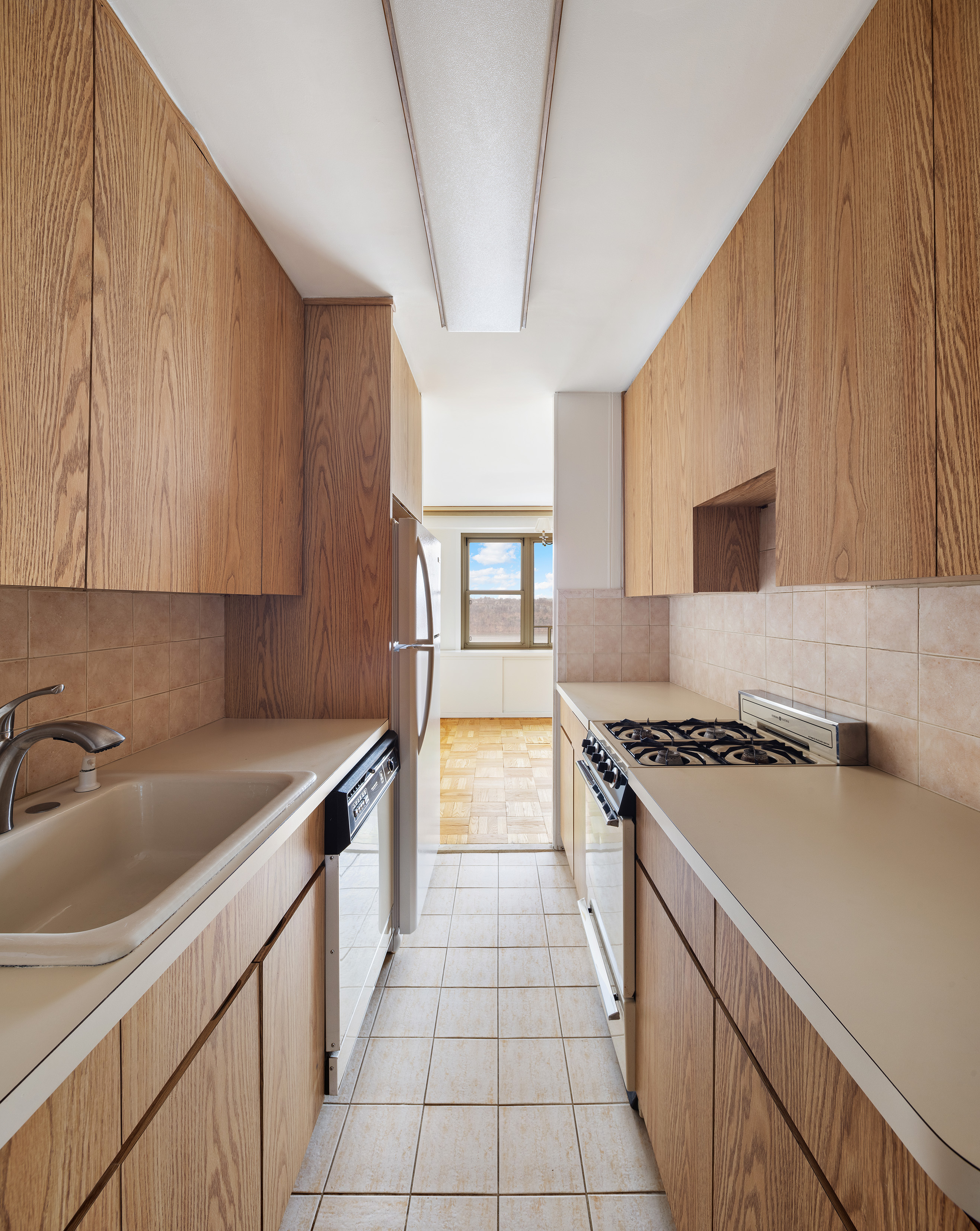 900 West 190th Street, Unit 10O Manhattan, NY 10040 - Photo 4 of 15 a kitchen with a sink stove and cabinets