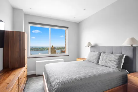 a bedroom with a large bed and a large window