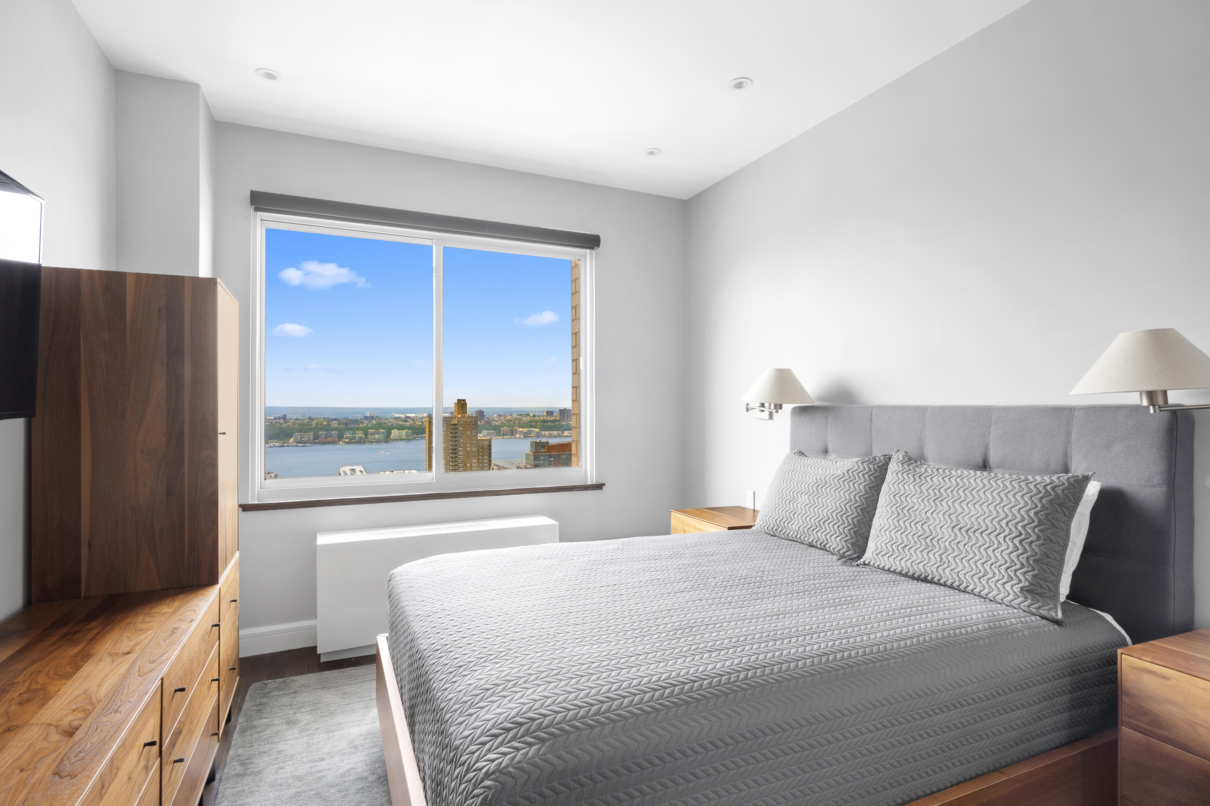 350 West 50th Street, Unit PH4B Manhattan, NY 10019 - Photo 6 of 18 a bedroom with a large bed and a large window