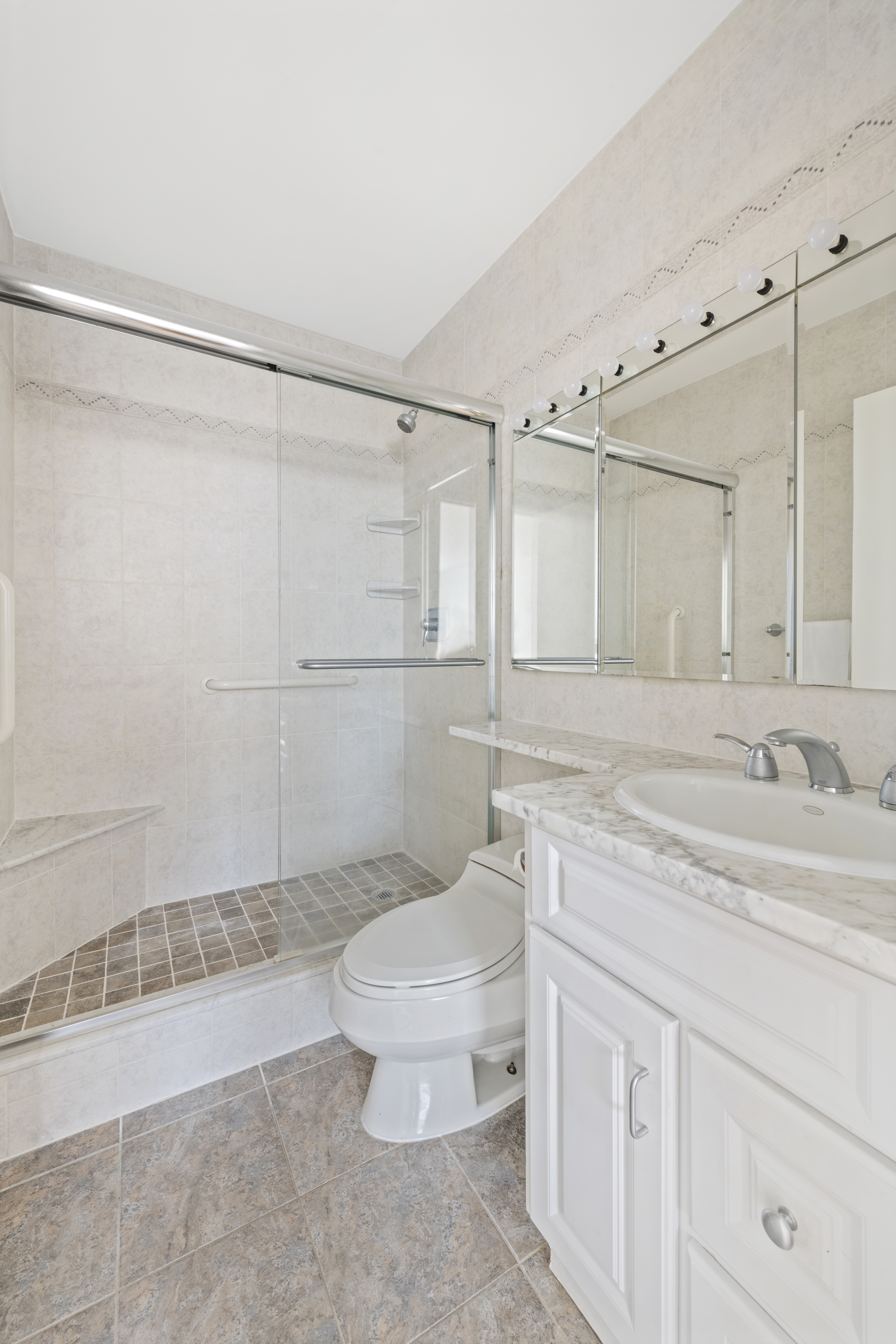 171 East 84th Street, Unit 31C Manhattan, NY 10028 - Photo 10 of 18 a bathroom with a sink a toilet and shower