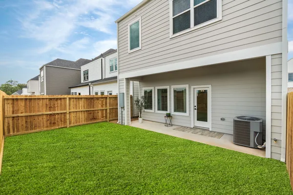 a view of a house with a yard and sitting area